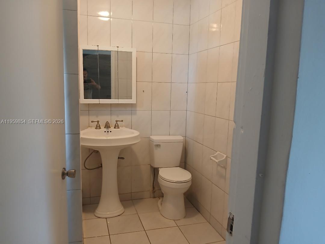 1535 Northwest 85th Street Miami, FL 33147 - Photo 2 of 7 a bathroom with a sink toilet and shower