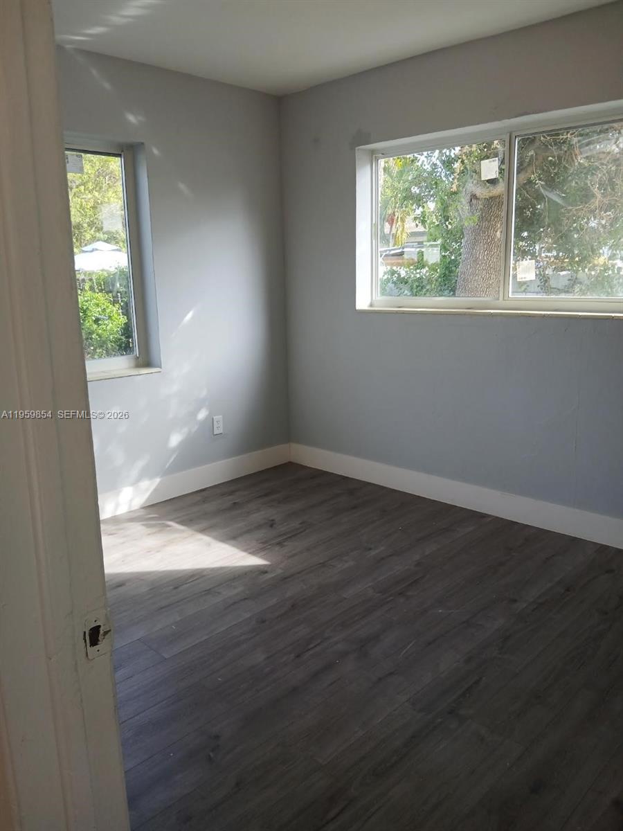 1535 Northwest 85th Street Miami, FL 33147 - Photo 7 of 7 an empty room with wooden floor and windows