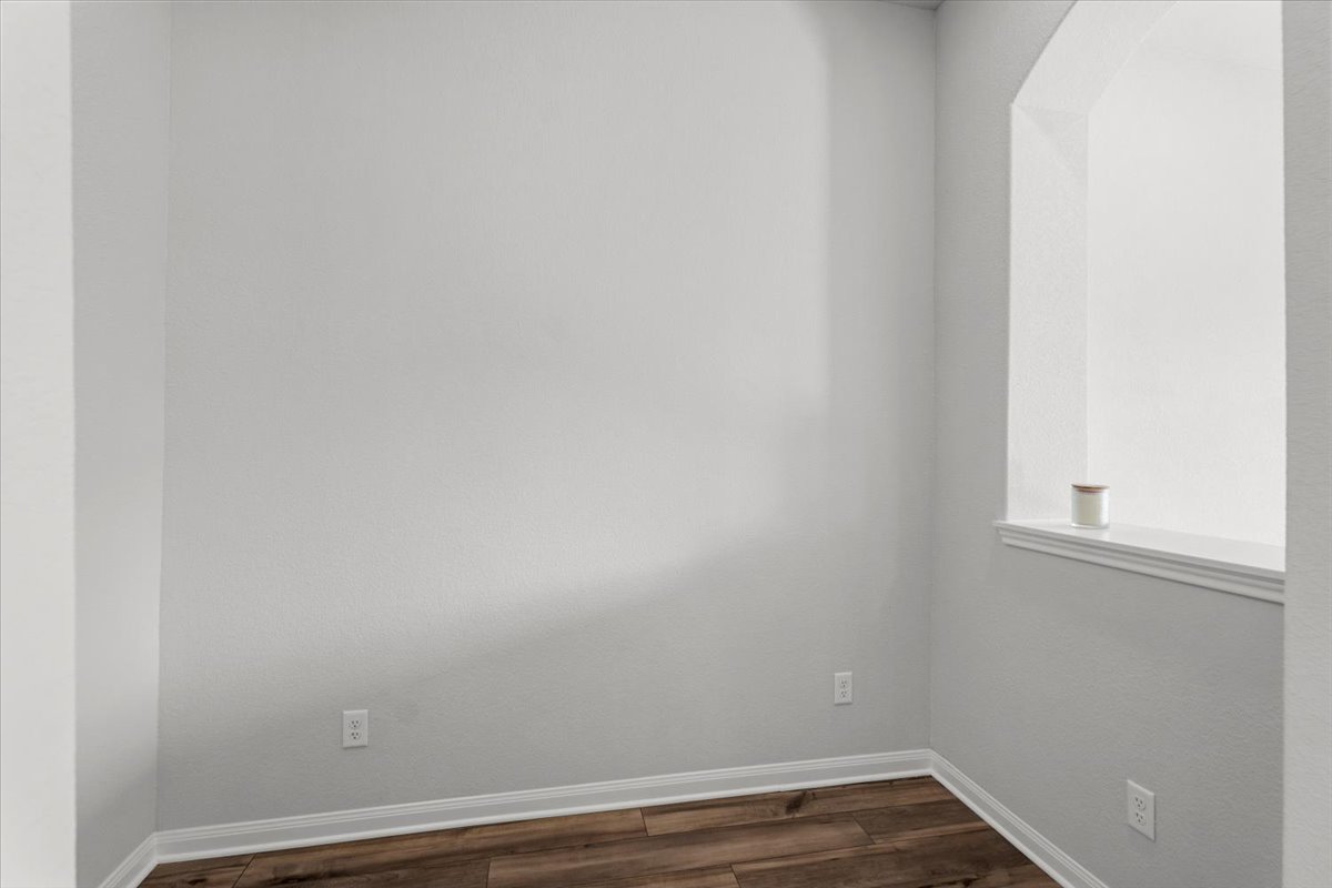 8513 Wellspring Loop Round Rock, TX 78665 - Photo 13 of 40 Unfurnished room featuring dark wood finished floors and baseboards