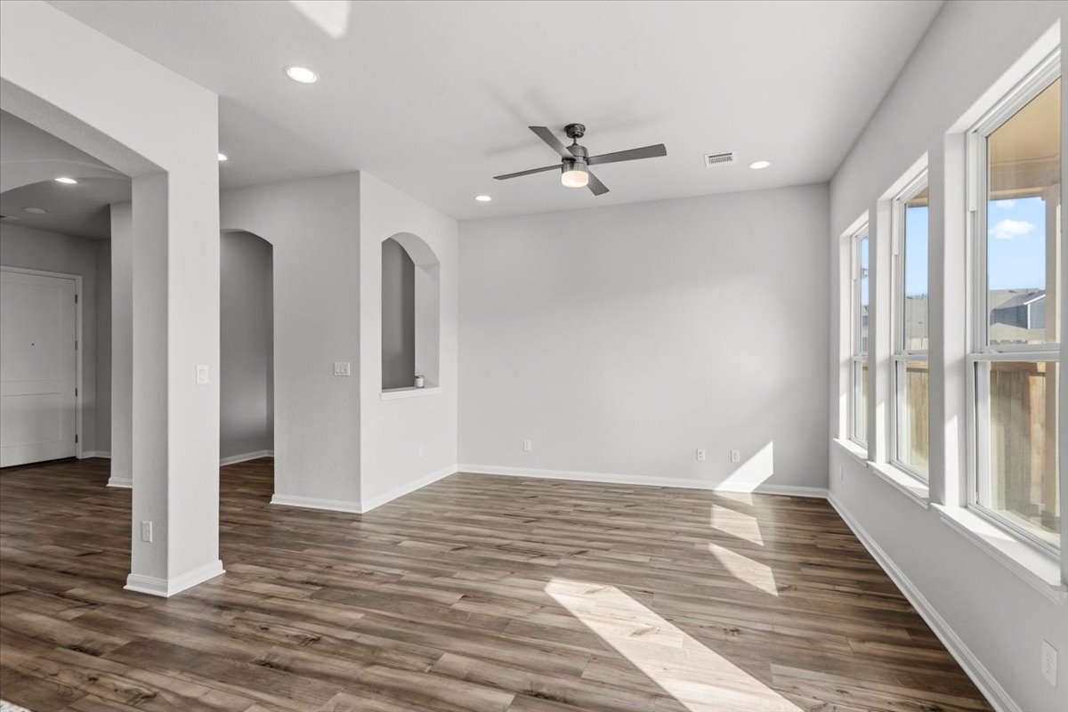 8513 Wellspring Loop Round Rock, TX 78665 - Photo 14 of 40 Spare room featuring ceiling fan, light wood finished floors, arched walkways, and recessed lighting