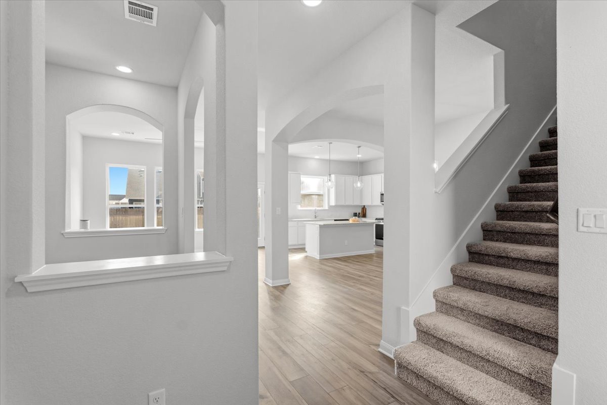 8513 Wellspring Loop Round Rock, TX 78665 - Photo 16 of 40 Entryway with arched walkways, light wood-style flooring, and recessed lighting