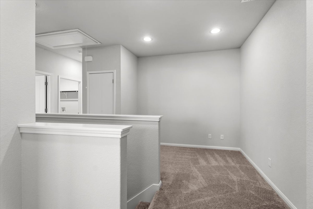 8513 Wellspring Loop Round Rock, TX 78665 - Photo 17 of 40 Hall with carpet flooring, recessed lighting, and an upstairs landing