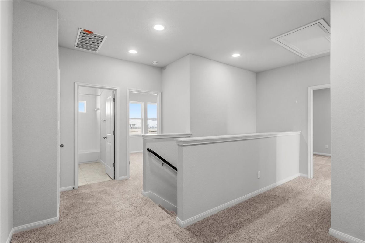 8513 Wellspring Loop Round Rock, TX 78665 - Photo 18 of 40 Hallway featuring light carpet, recessed lighting, and an upstairs landing