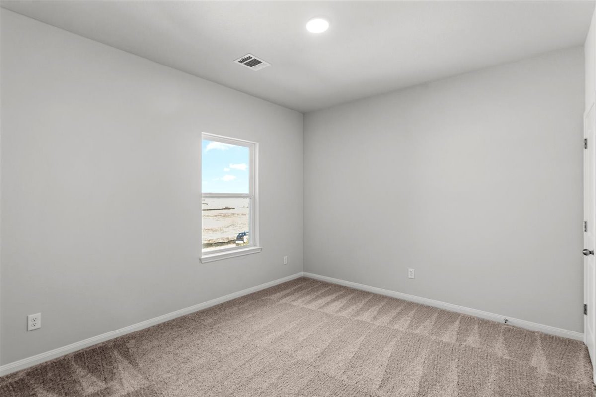 8513 Wellspring Loop Round Rock, TX 78665 - Photo 19 of 40 Empty room featuring light colored carpet and recessed lighting