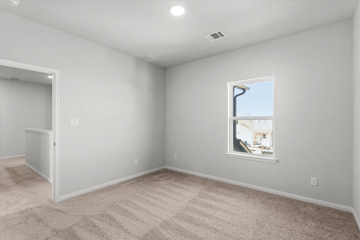 8513 Wellspring Loop Round Rock, TX 78665 - Photo 20 of 40 Empty room with light carpet and recessed lighting
