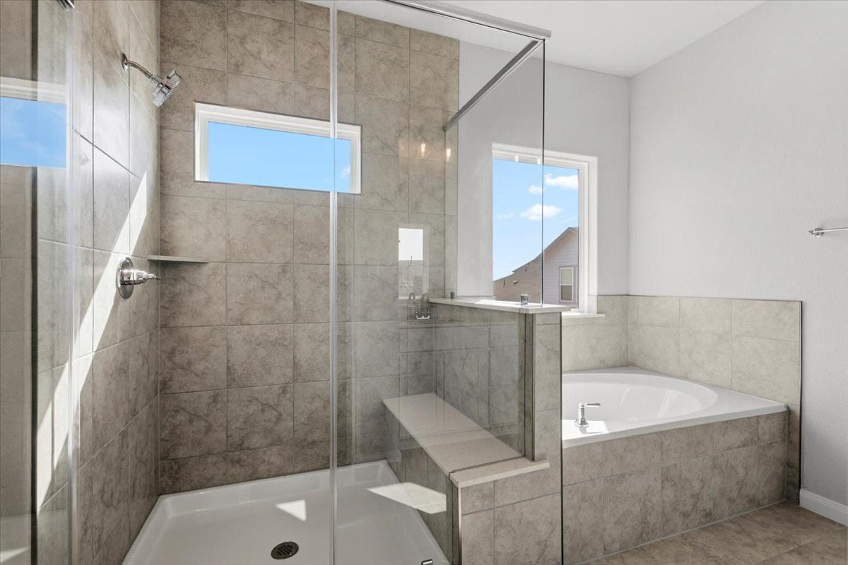 8513 Wellspring Loop Round Rock, TX 78665 - Photo 25 of 40 Bathroom with a bath, a shower stall, and healthy amount of natural light