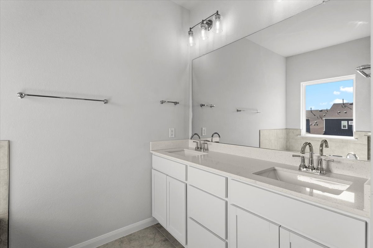 8513 Wellspring Loop Round Rock, TX 78665 - Photo 26 of 40 Bathroom with double vanity and baseboards