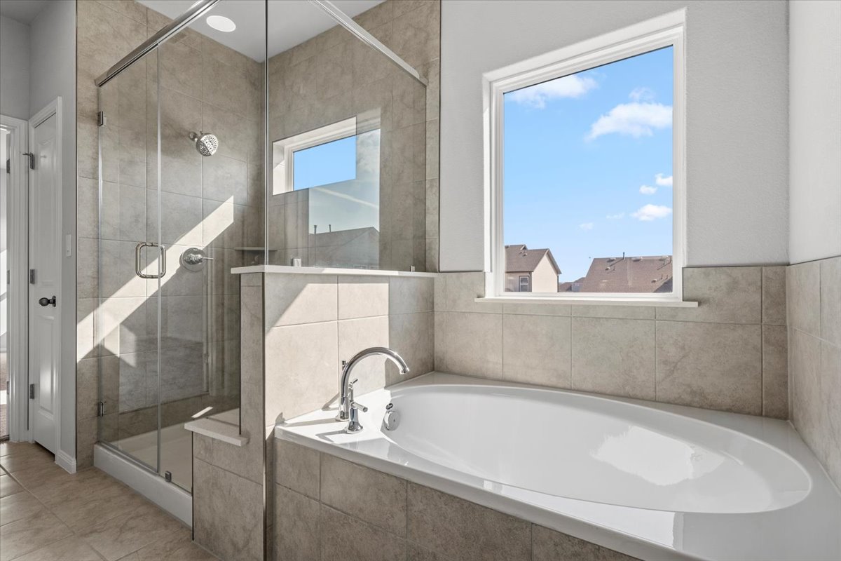 8513 Wellspring Loop Round Rock, TX 78665 - Photo 27 of 40 Full bathroom with a garden tub and a shower stall