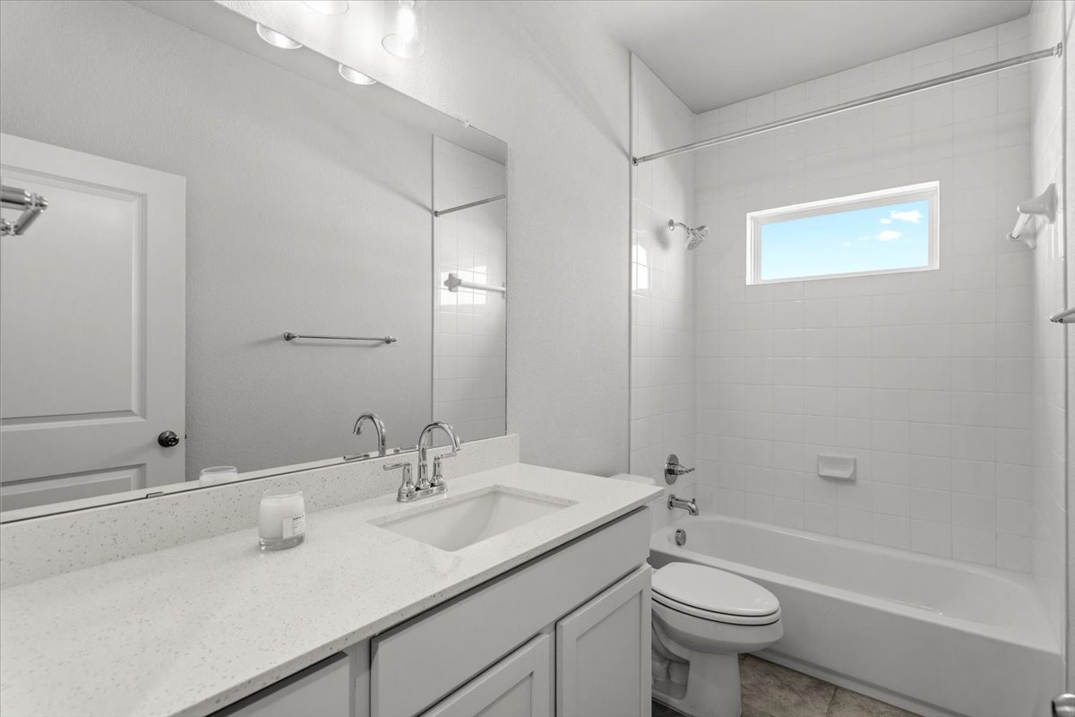 8513 Wellspring Loop Round Rock, TX 78665 - Photo 31 of 40 Bathroom with vanity, shower / tub combination, and tile patterned floors