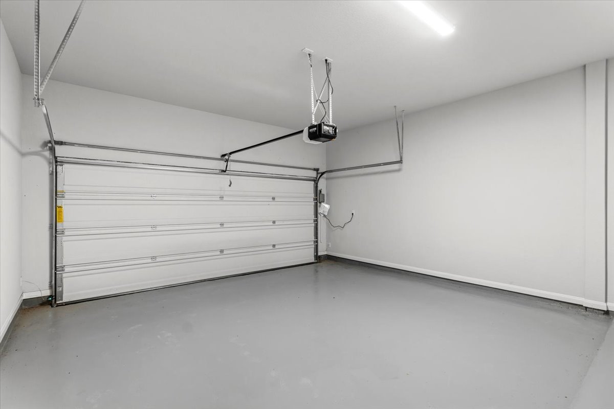 8513 Wellspring Loop Round Rock, TX 78665 - Photo 32 of 40 Garage with baseboards and a garage door opener