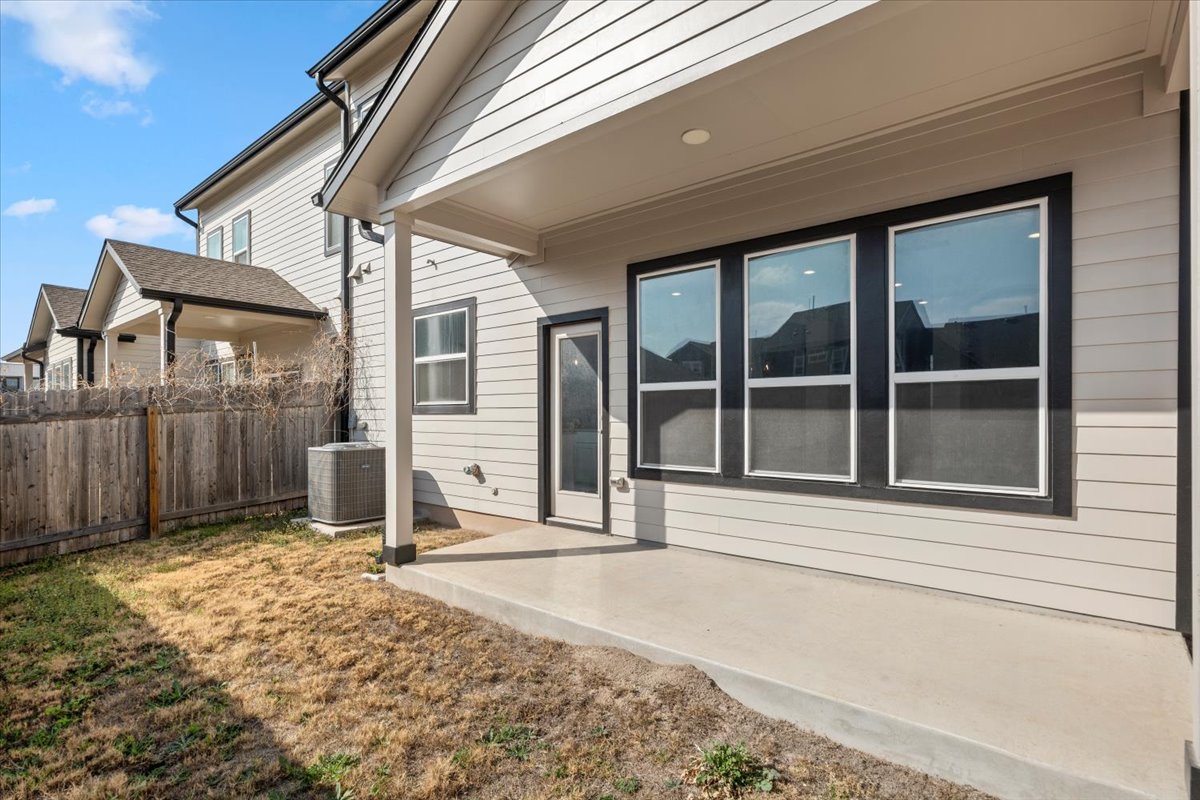 8513 Wellspring Loop Round Rock, TX 78665 - Photo 4 of 40 View of side of home featuring a patio area and a central AC unit