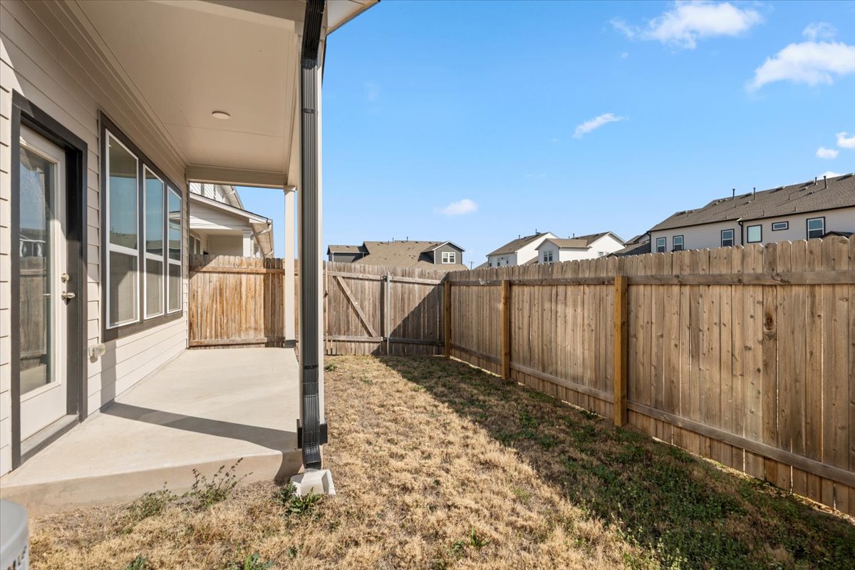 8513 Wellspring Loop Round Rock, TX 78665 - Photo 6 of 40 Fenced backyard with a patio area and a residential view