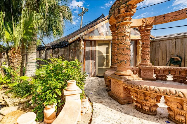 a view of an house with backyard and sitting area