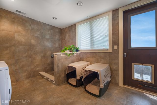 a view of a hallway with couch and door