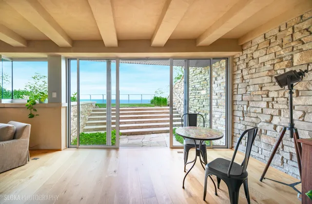 a view of a patio with table and chairs and potted plants
