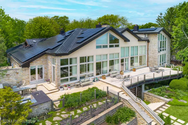 an aerial view of a house a yard and mountain view