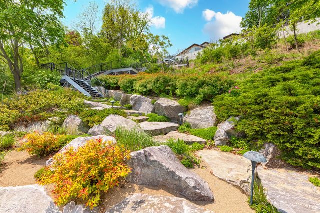 an aerial view of a house with a yard and lake view