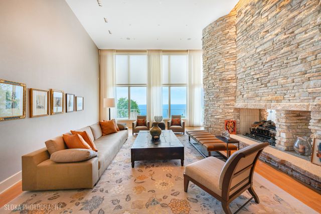 a living room with furniture and floor to ceiling windows
