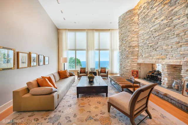 a living room with furniture and floor to ceiling windows