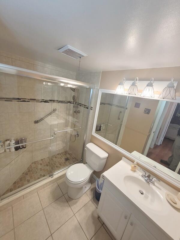 320 Pine Ridge Circle, Unit A1 Greenacres, FL 33463 - Photo 13 of 65 a bathroom with a sink and a mirror