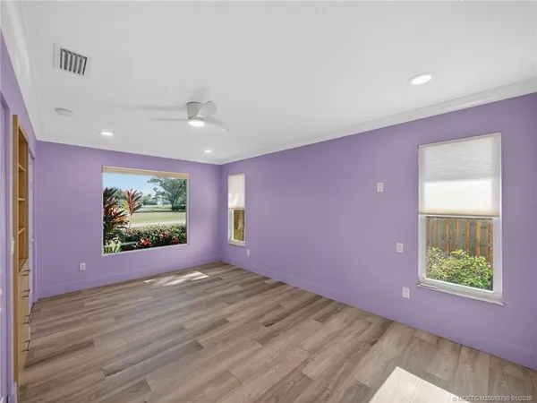 wooden floor in an empty room with a window