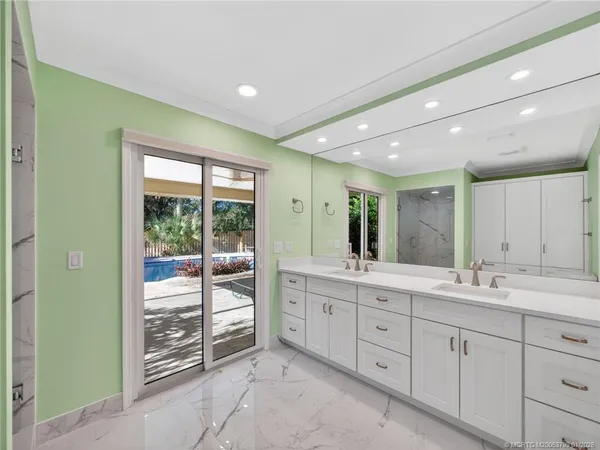 a bathroom with a double vanity sink and a window
