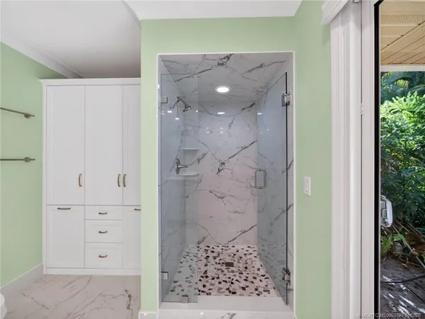 view of a bathroom with a shower and a sink
