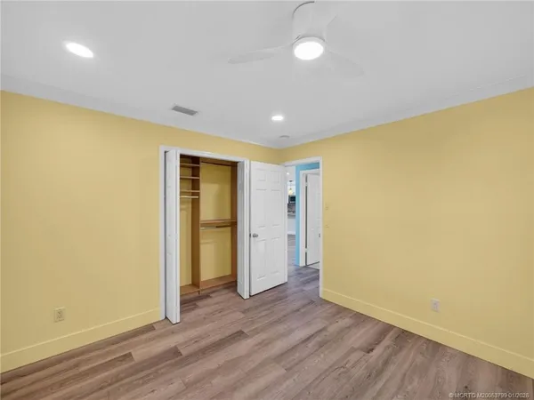a view of hallway with wooden floor