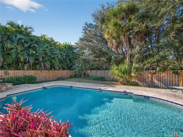 a view of a backyard with swimming pool