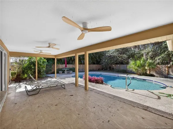 a view of a patio with a table and chairs