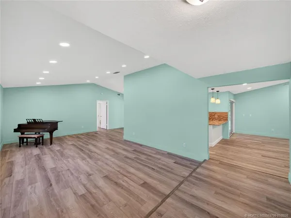 a view of a room with wooden floor