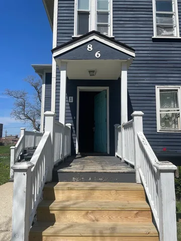 a view of a house with large windows and stairs