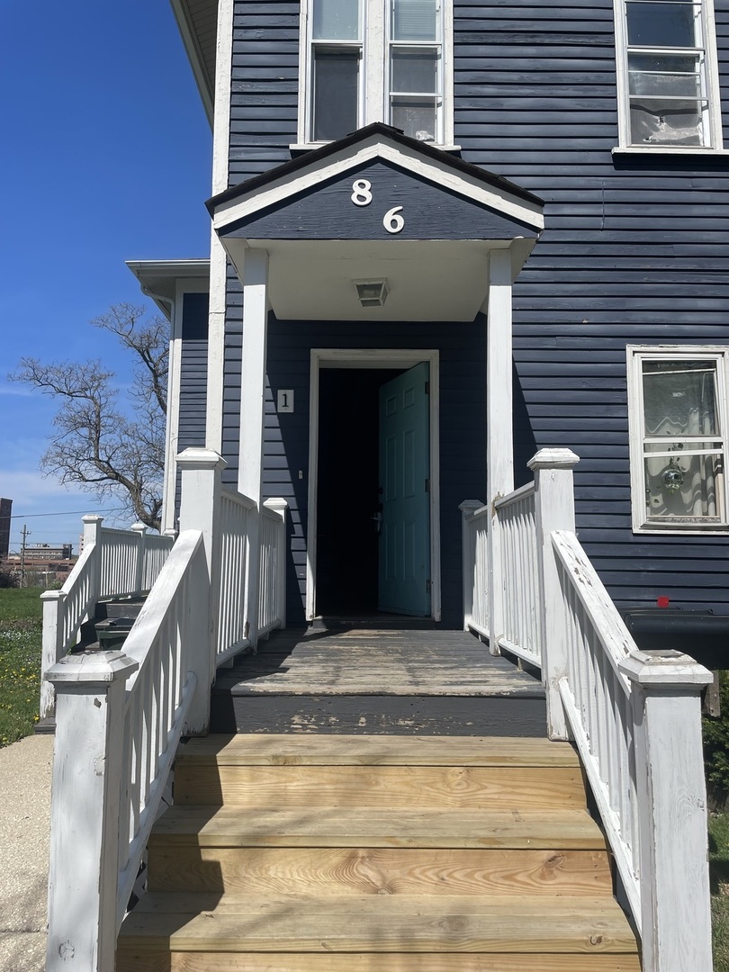 a view of a house with large windows and stairs