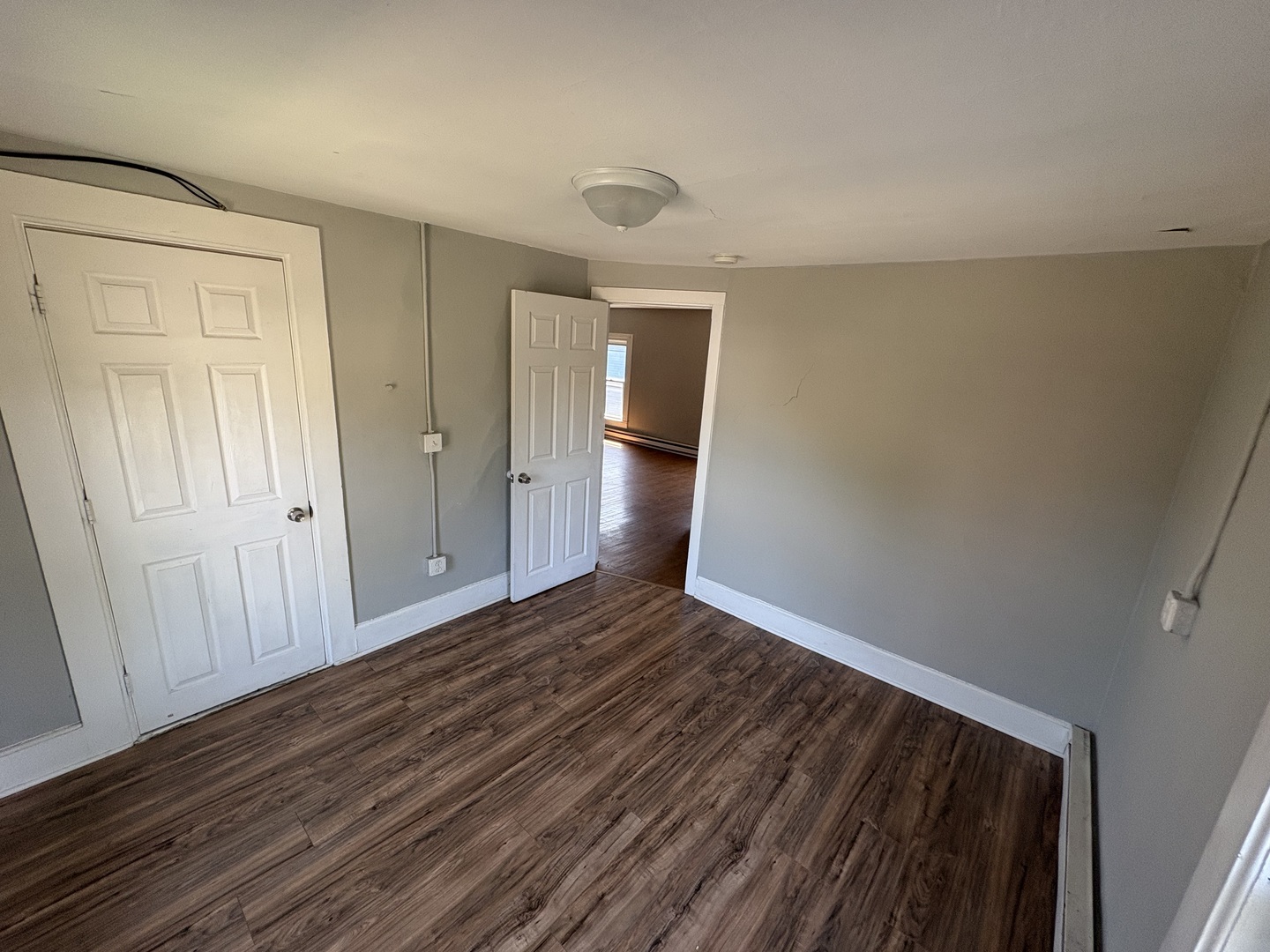 86 North 4th Street, Unit 1 Aurora, IL 60505 - Photo 2 of 10 a view of an empty room with wooden floor and closet