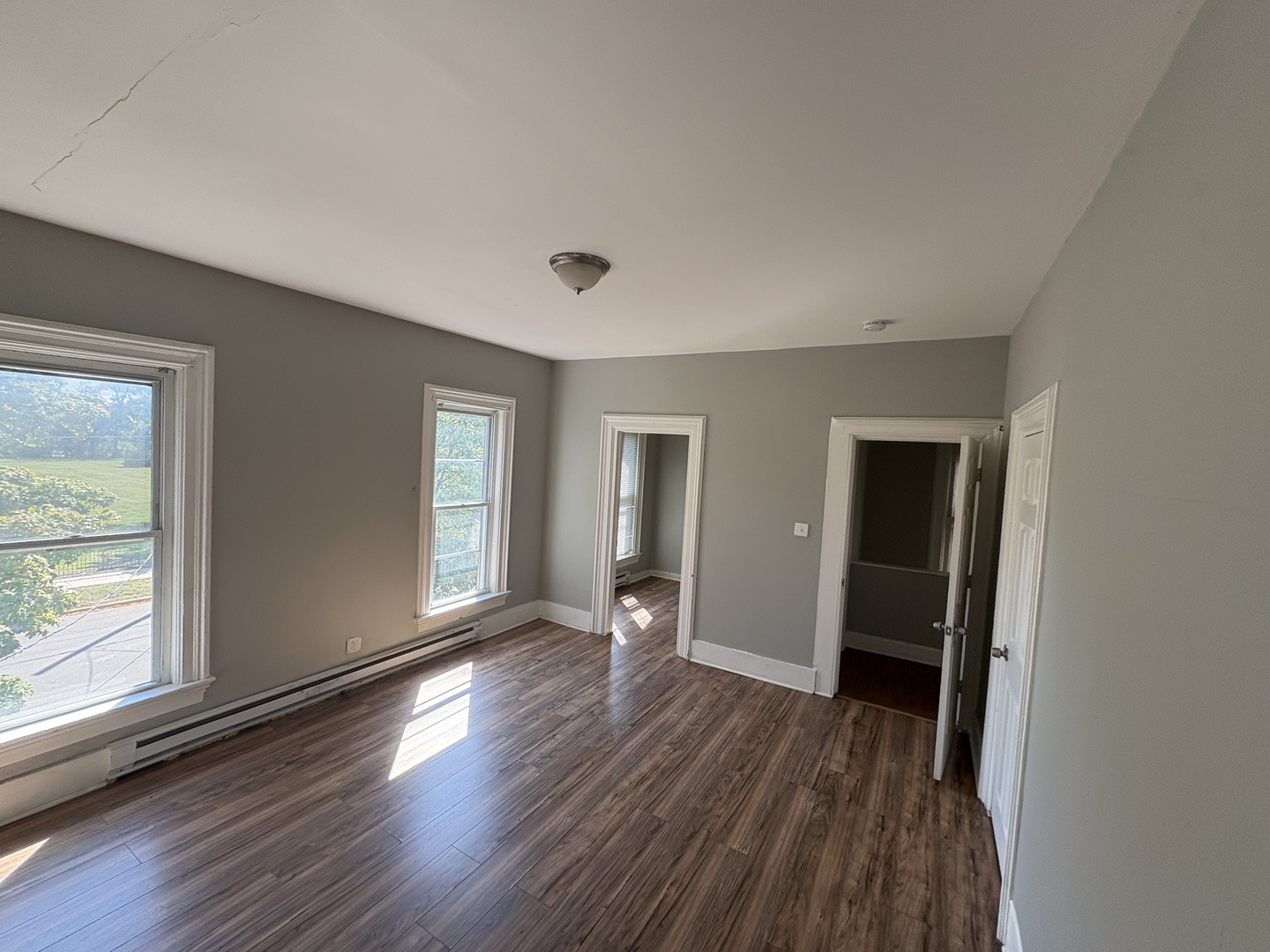 86 North 4th Street, Unit 1 Aurora, IL 60505 - Photo 5 of 10 wooden floor in an empty room with a window