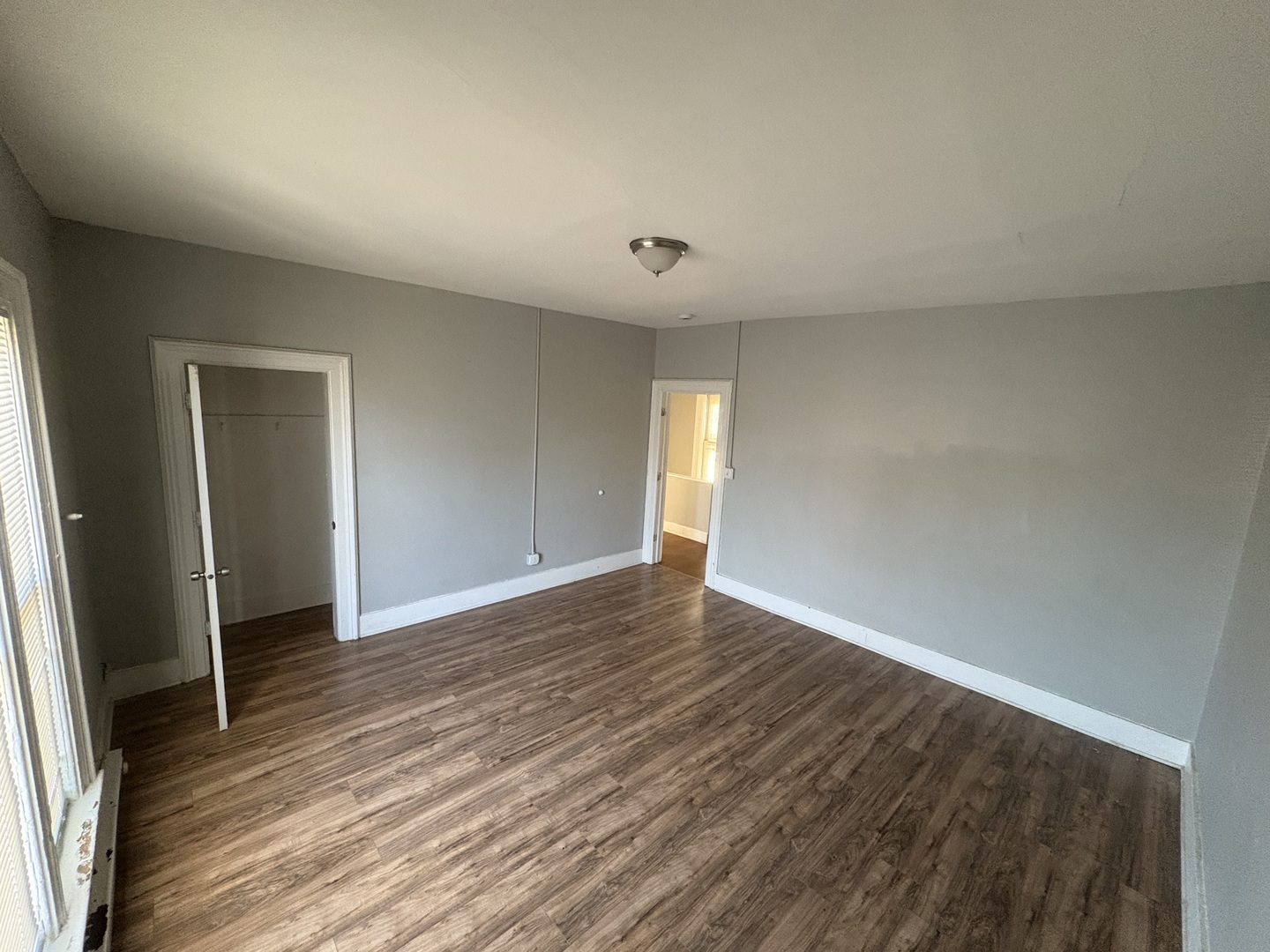 86 North 4th Street, Unit 1 Aurora, IL 60505 - Photo 6 of 10 a view of an empty room with wooden floor and a window