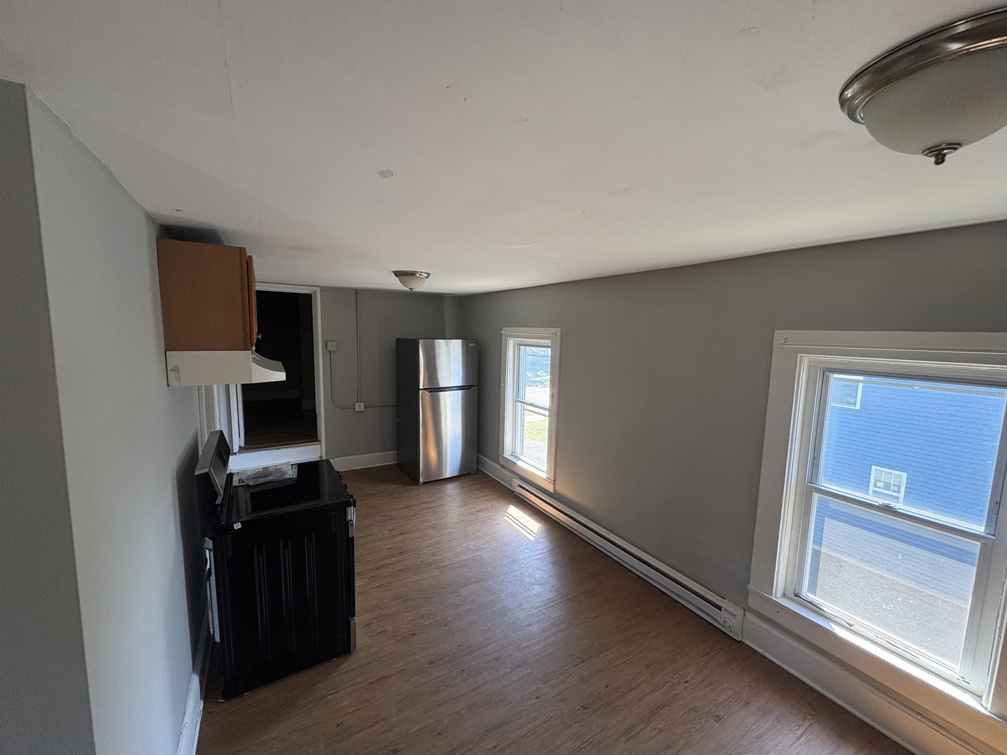 86 North 4th Street, Unit 1 Aurora, IL 60505 - Photo 9 of 10 a view of a kitchen with refrigerator and wooden floor