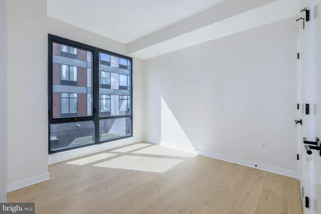 a view of an empty room with glass door