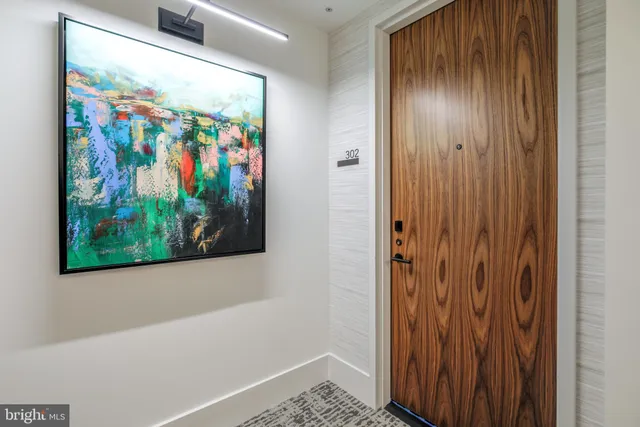 a view of a hallway with painting on the wall