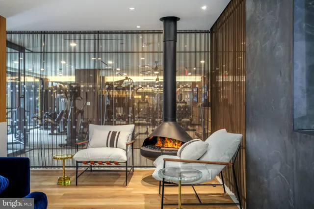 a living room with furniture and a floor to ceiling window