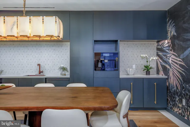 a kitchen with a table chairs sink and cabinets