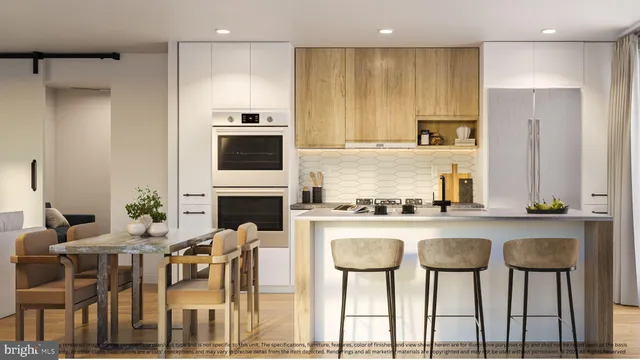 a kitchen with stainless steel appliances granite countertop a table chairs stove and refrigerator