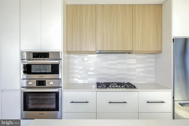 a kitchen with granite countertop cabinets stainless steel appliances and wooden cabinets