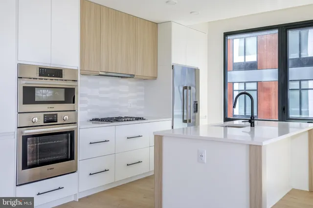 a kitchen with granite countertop a stove and a microwave