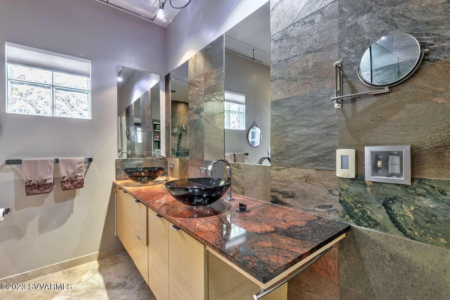 25 Homestead Road Sedona, AZ 86336 - Photo 24 of 25 a bathroom with a granite countertop sink a mirror and shower