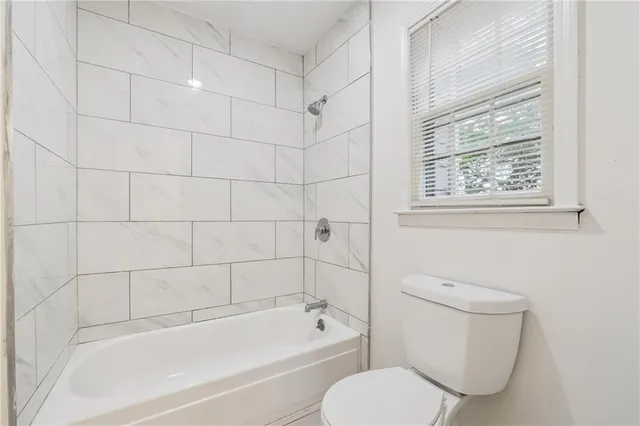 a bathroom with a toilet and a bathtub