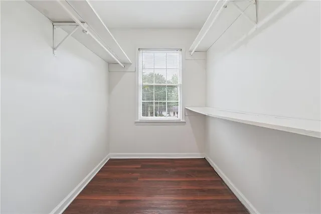a view of a room with wooden floor and windows in a room