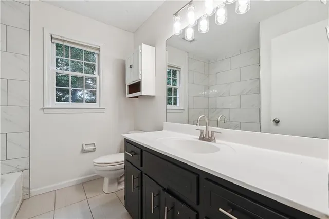 a bathroom with a sink a toilet and a bathtub