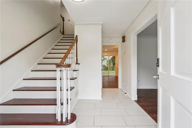 a view of entryway and hall with wooden floor