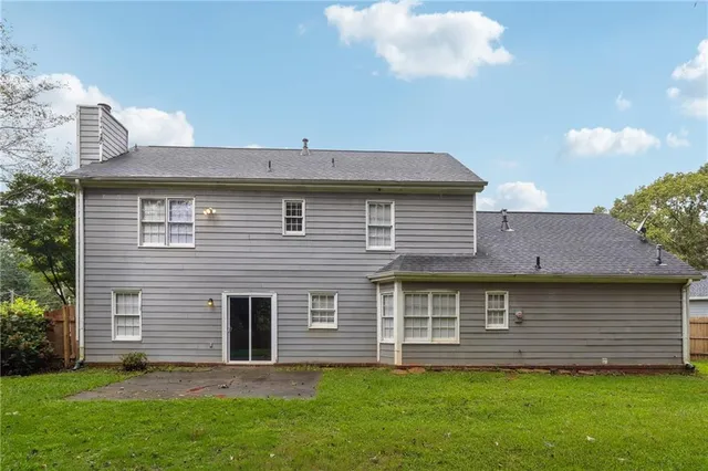 a front view of a house with a garden and yard